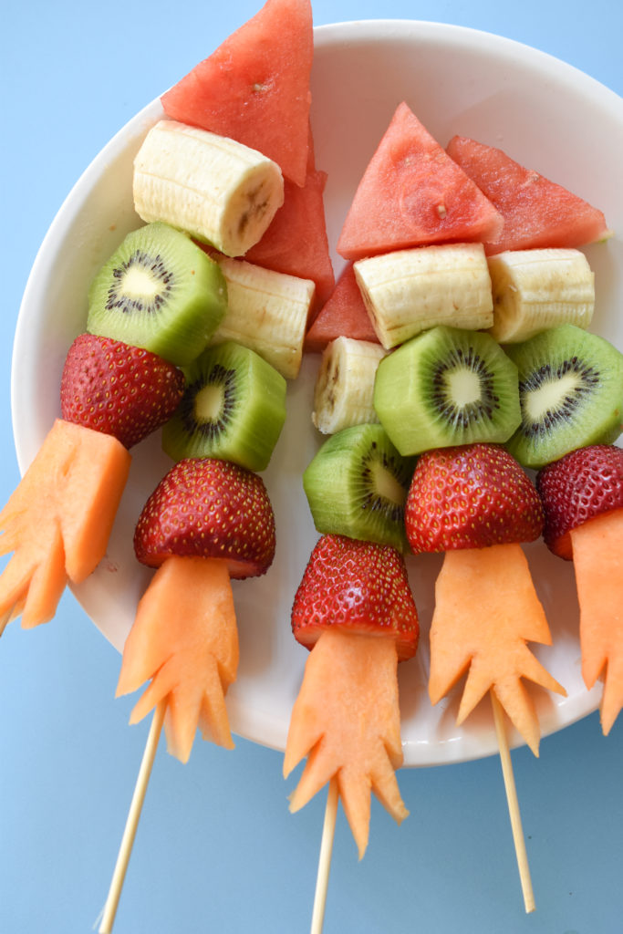 Keep your kids safe, healthy, and entertained this summer with these DIY Firecracker Fruit Kabobs!