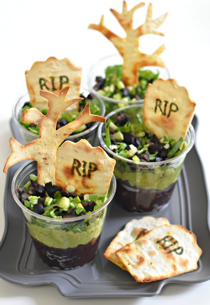 Turn dinner into an easy Halloween-themed meal by layering simple ingredients over each other to make them in Graveyard Taco Cups. Careful for ghosts!