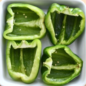 A dish with 4 green bell pepper halves