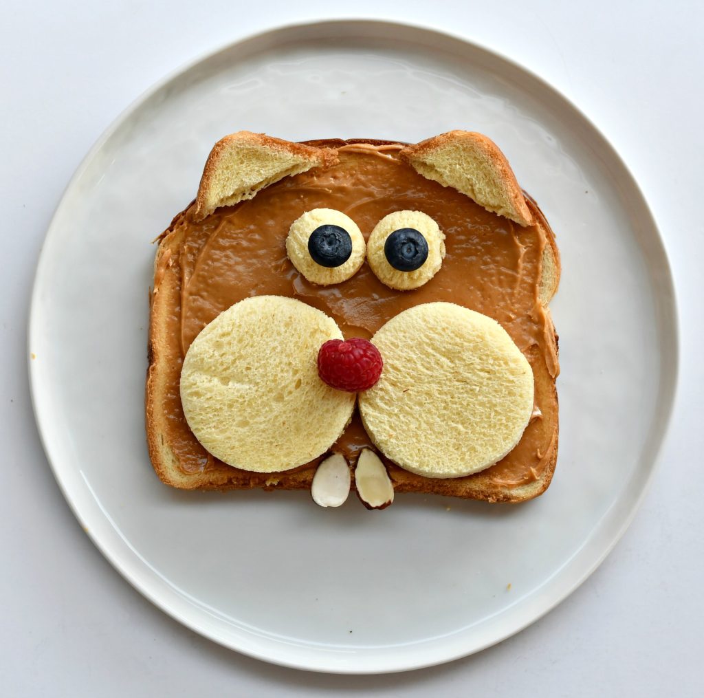 A piece of bread on a plate that looks like a groundhog.