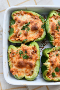 A dish with 4 lasagna stuffed peppers