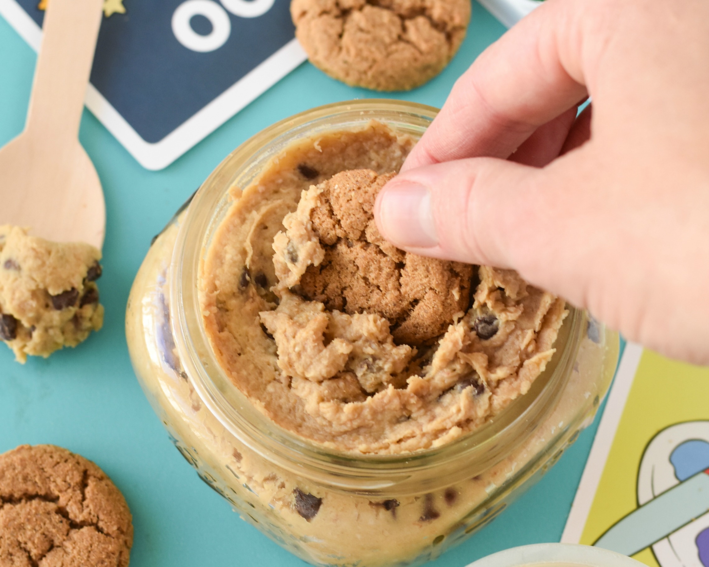 Handing dipping into a jar of cookie dough hummus