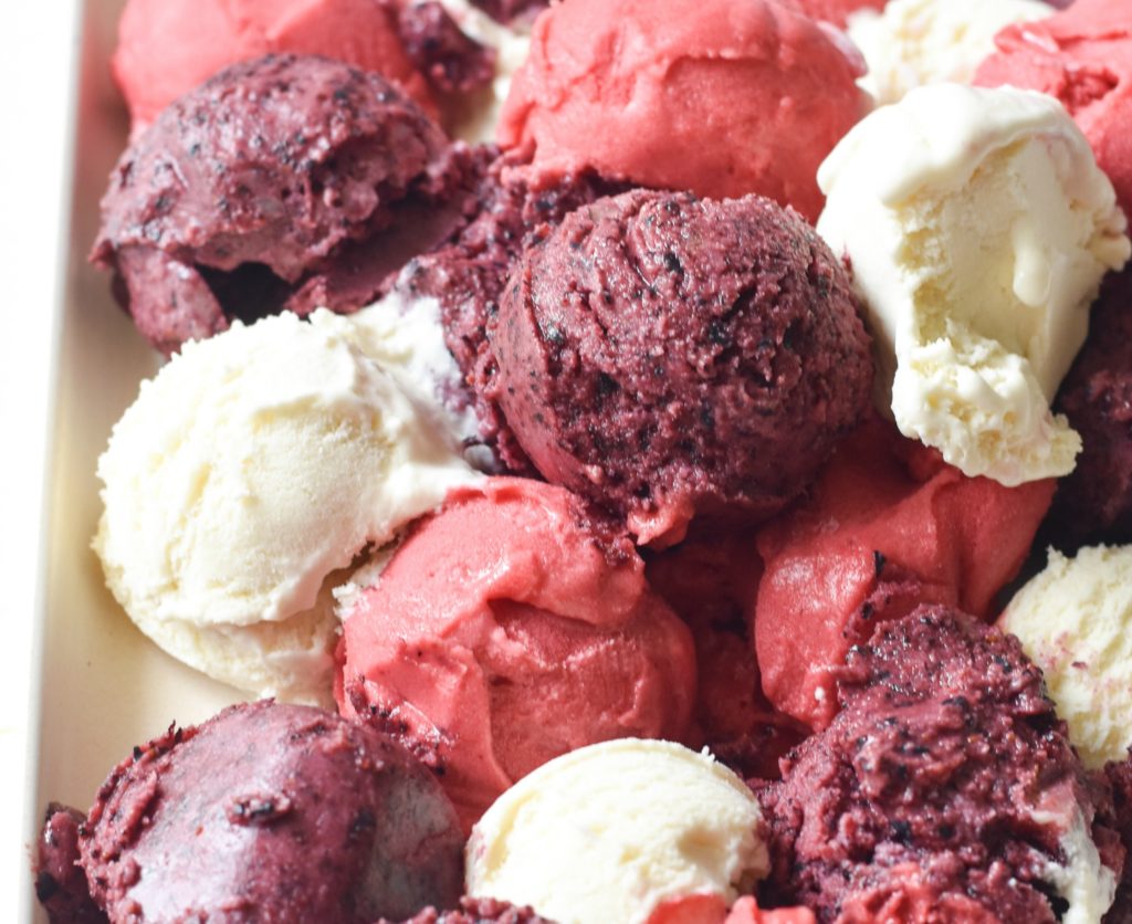 Scoops of berry frozen yogurt piled on top of each other