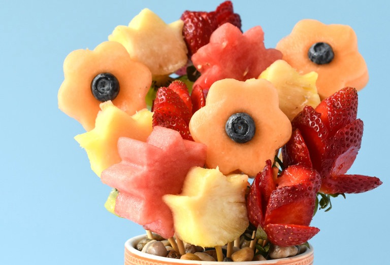 a bouquet of fruit cut and made to look like flowers
