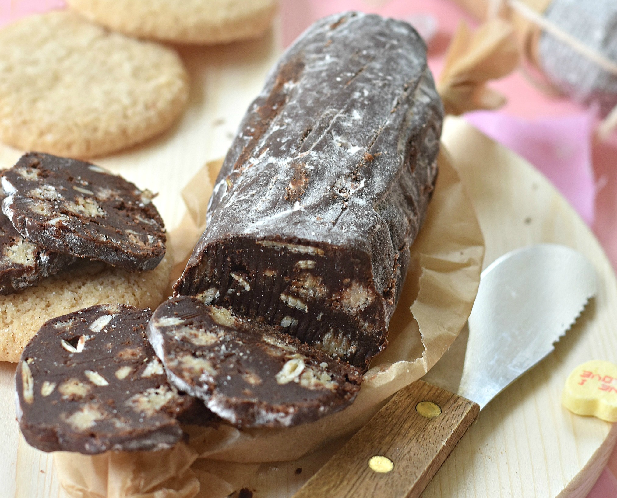 A cutting board of chocolate salami, cut into slices.