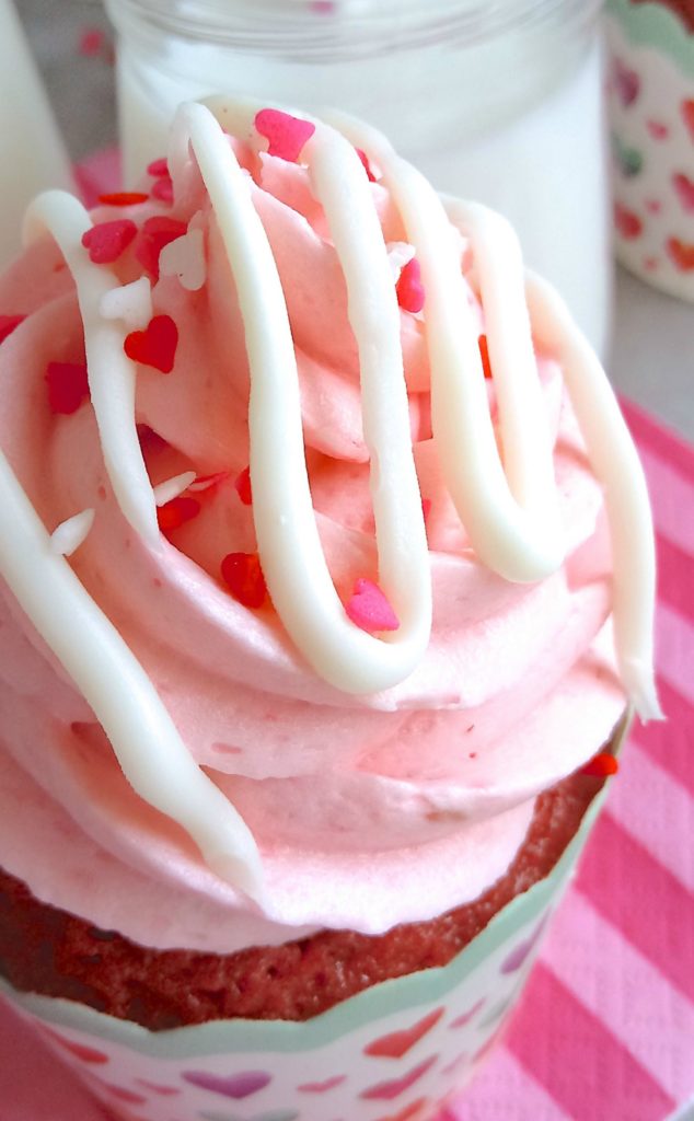 A close up of the Valentines Day Cupcakes with pink frosting and a white chocolate drizzle.