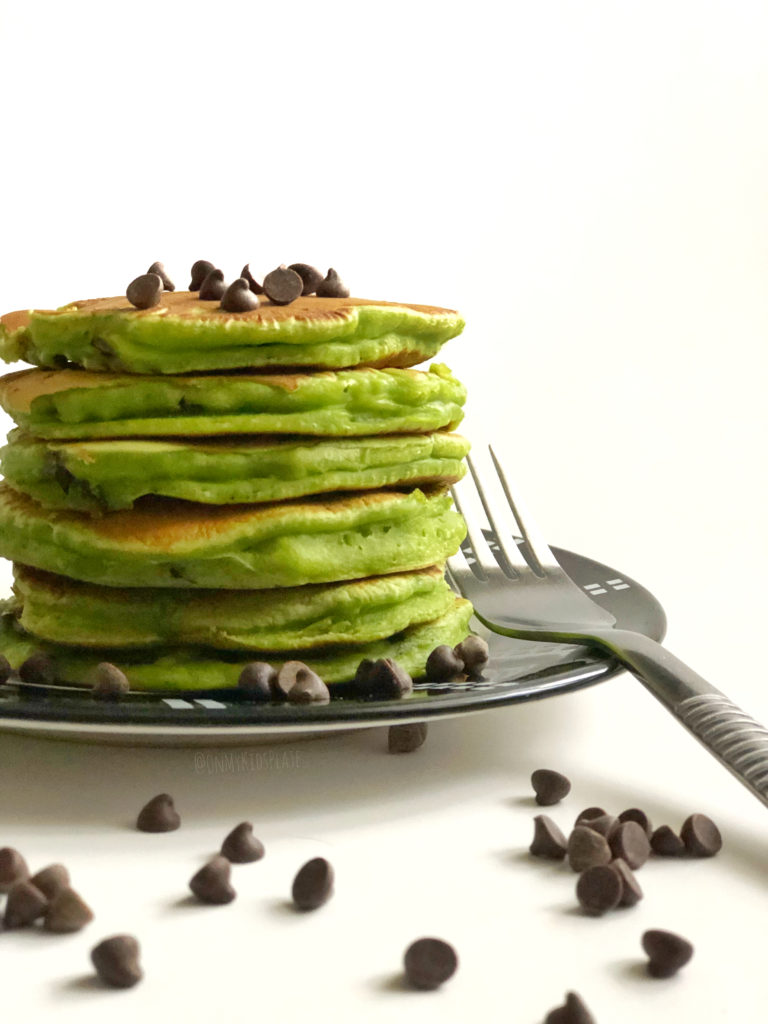 A stack of green mint chocolate chip pancakes