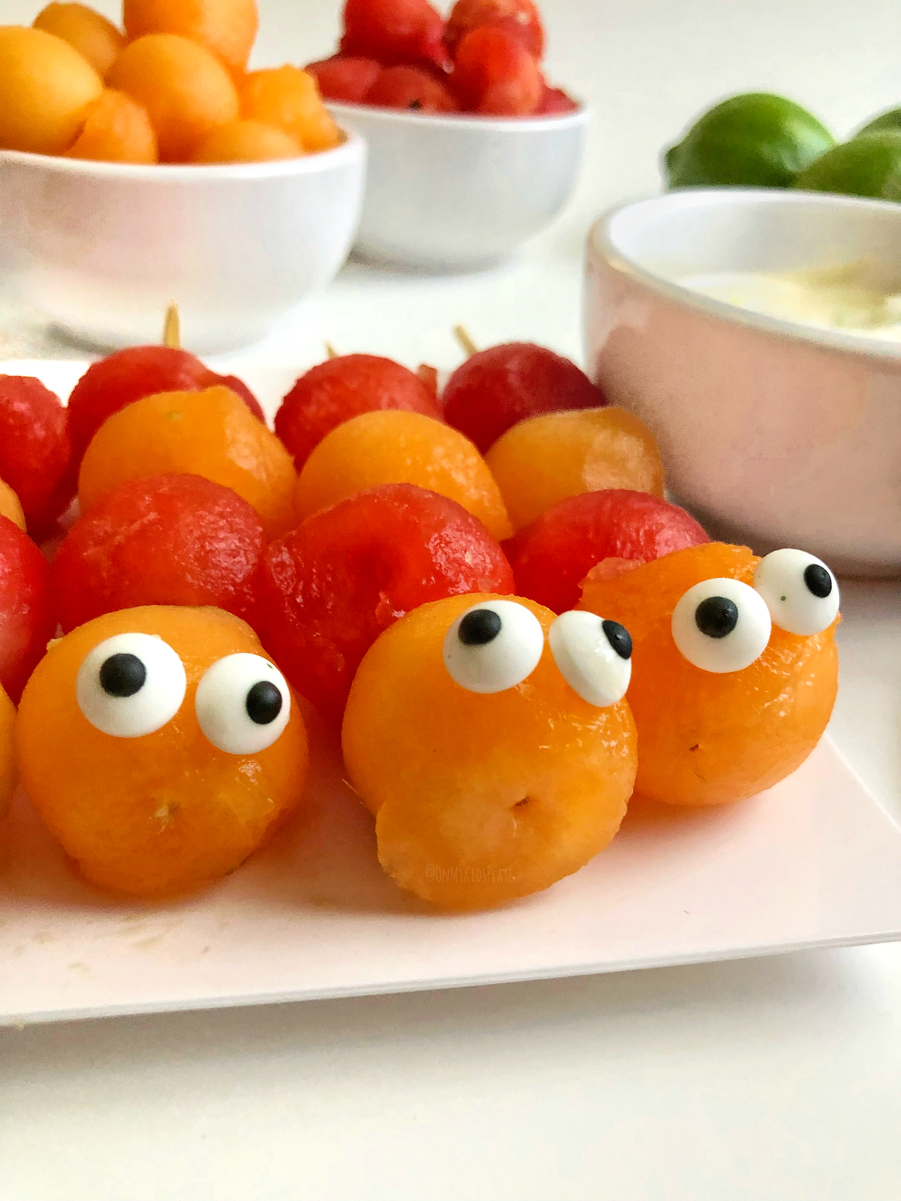 Cute pre-made Caterpillar Fruit Kebabs, ready for dipping 