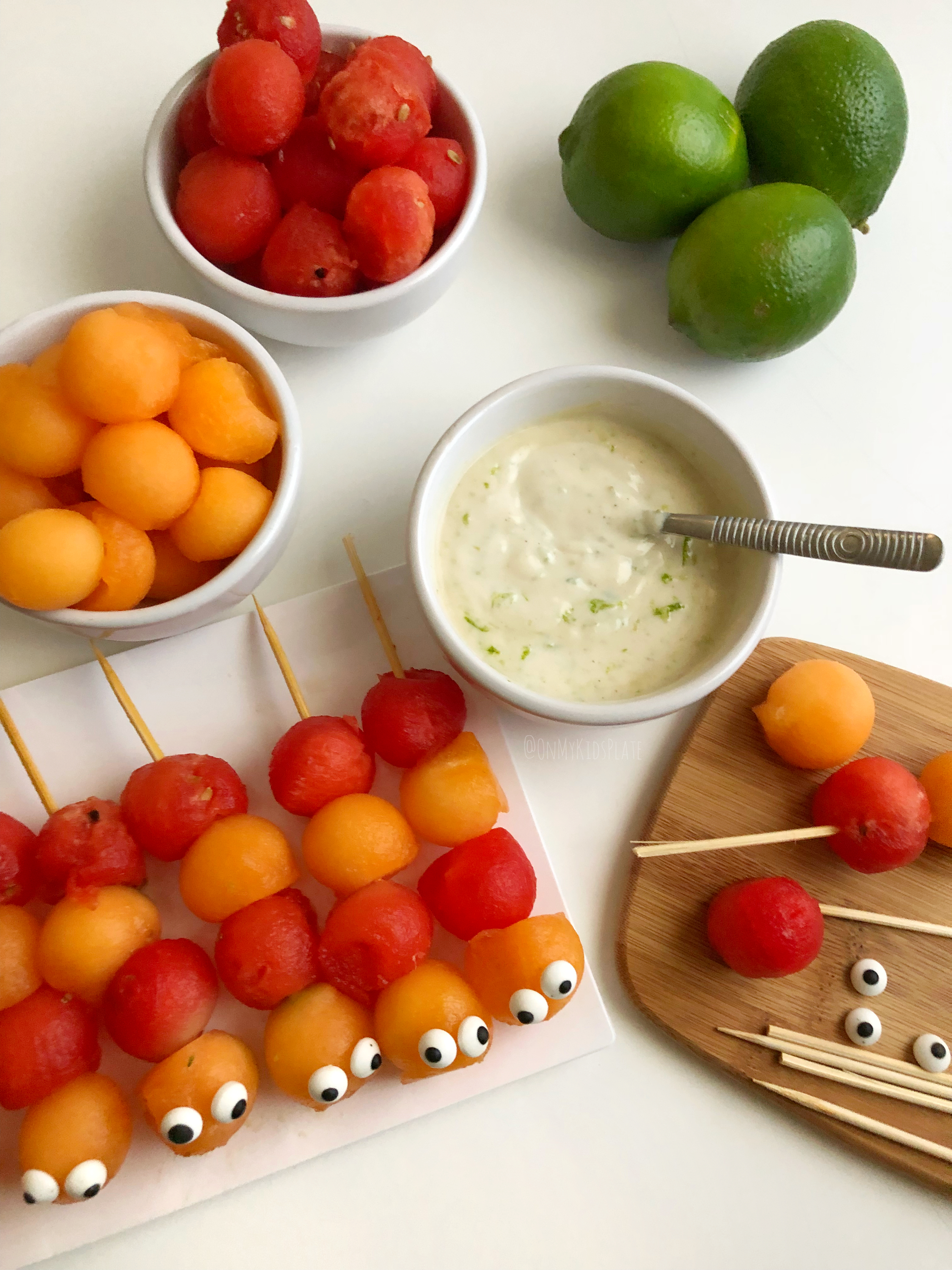 Cute pre-made Caterpillar Fruit Kebabs, ready for dipping 