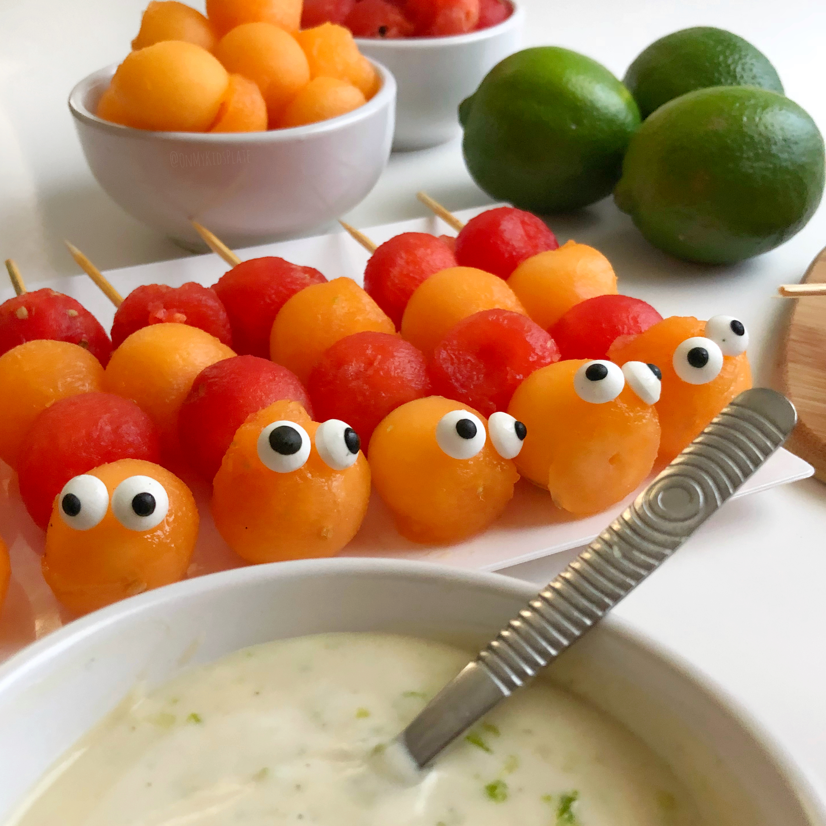 Cute pre-made Caterpillar Fruit Kebabs, ready for dipping 