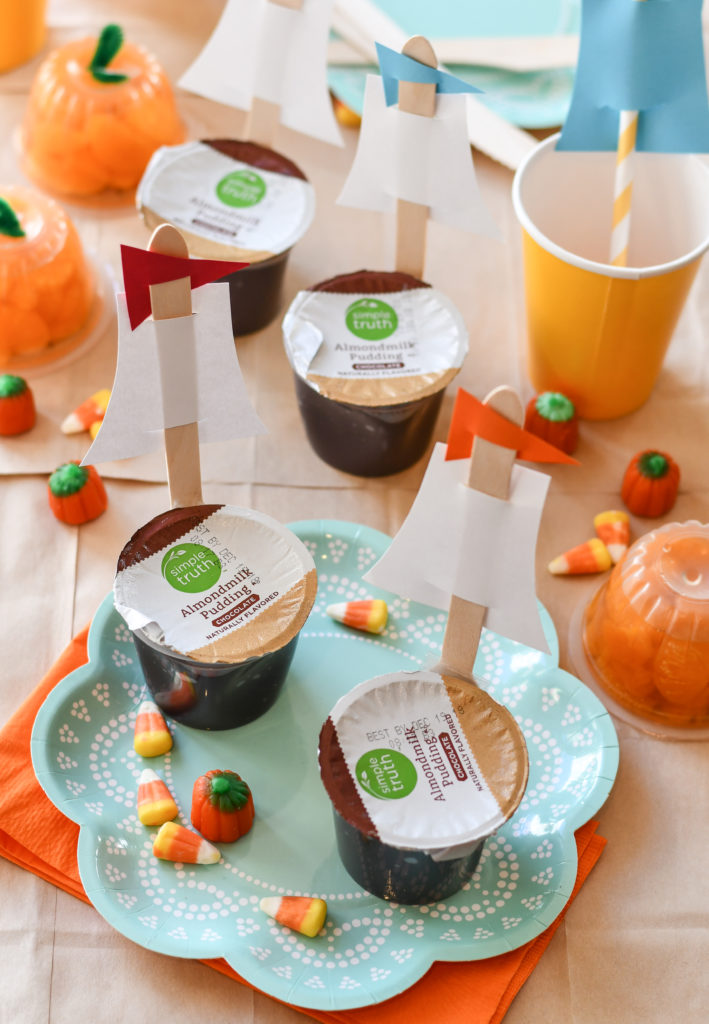 A thanksgiving table set for kids with dairy free Mayflower Pudding Cups on a turquoise plate