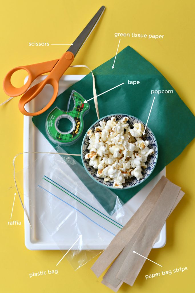 A yellow background with the materials needed to make Popcorn on the Cob Snack Bags