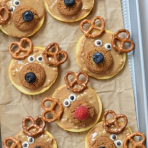 Sliced Opal apples covered with peanut butter and pretzel antlers, these Reindeer Apple Slices are a snack that every kid will love this Christmas #christmasfunfood #funkidfood