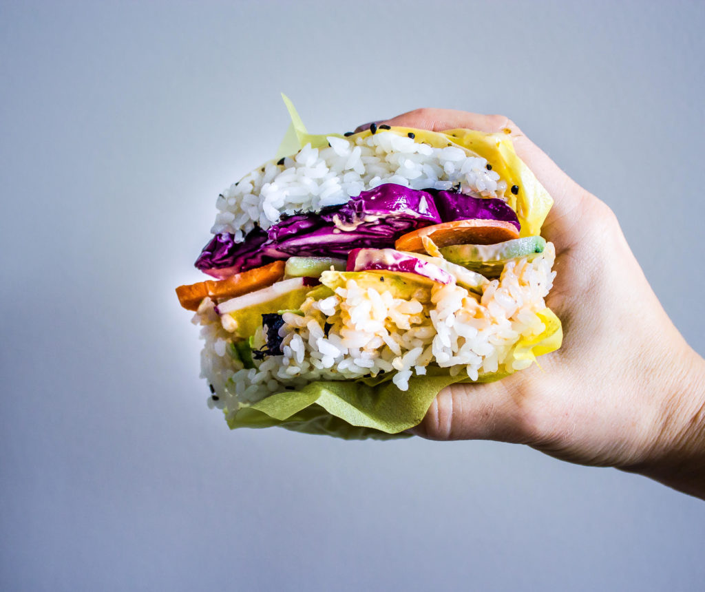 Get your kids involved with piling on the veggies on these Rainbow Sushi Burgers for a perfect meatless meal that all can participate in making & will love! #veganrecipes #kidfood #sushi #dinner