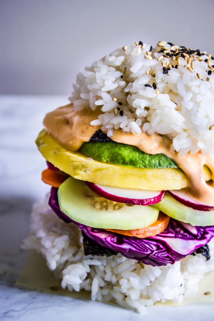Get your kids involved with piling on the veggies on these Rainbow Sushi Burgers for a perfect meatless meal that all can participate in making & will love! #veganrecipes #kidfood #sushi #dinner