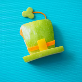 A teal background with a how-to on making Leprechaun Apple Hats