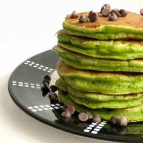 A stack of green mint chocolate chip pancakes